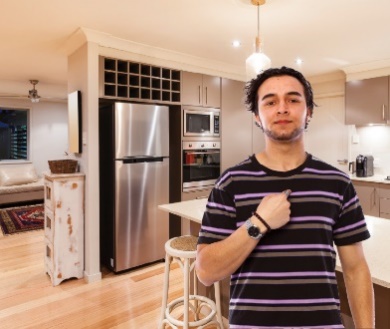 man pointing at himself inside a house