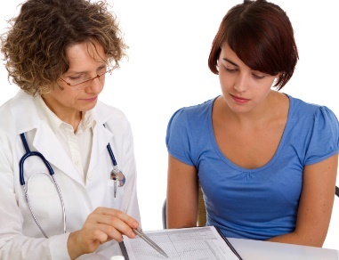 doctor explaining document to woman