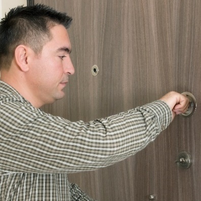 man locking door