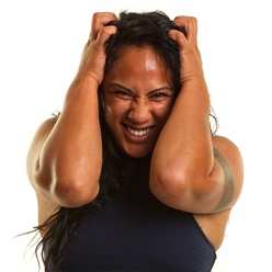stressed woman clutching her head
