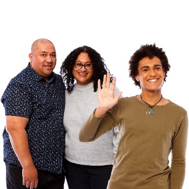 Someone raising their hand in front of 2 family members.